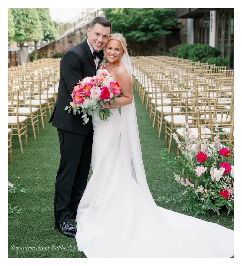 groom and bride holding bright pink and white bridal bouquet