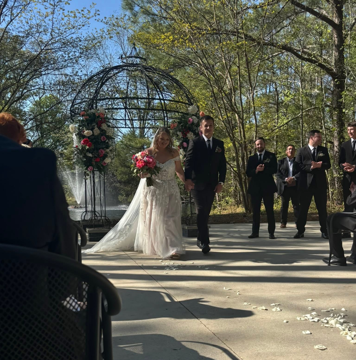 bride and groom holding hands at altar